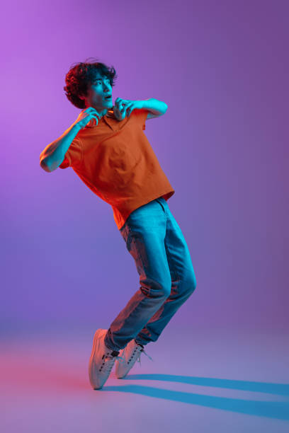 istock Happy man in casual clothes isolated over gradient background in neon light 1310095596