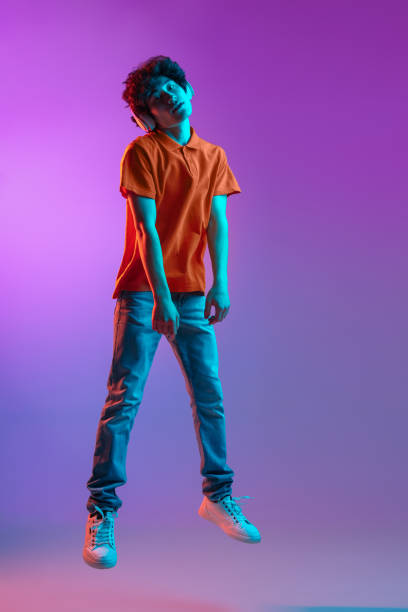 istock Happy man in casual clothes isolated over gradient background in neon light 1310095601