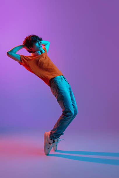 istock Happy man in casual clothes isolated over gradient background in neon light 1310095603