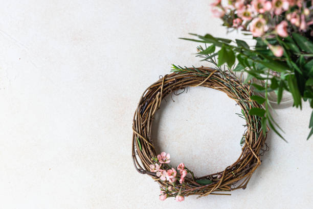 istock Decorative spring wreath made of twigs and flowers. DIY creativity. Top view. Copy space. 1310095825