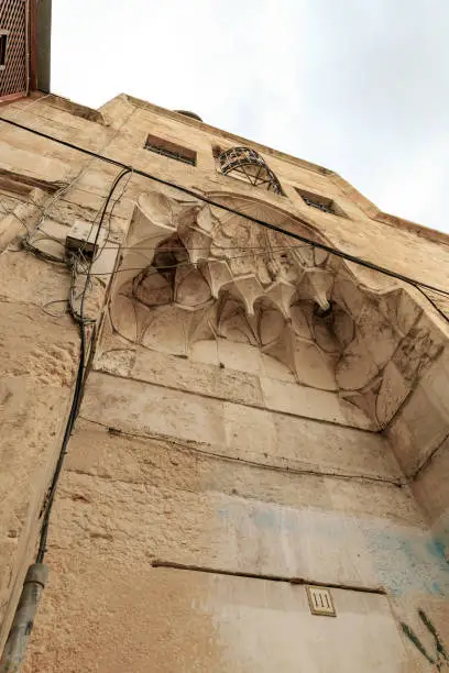 The facade of a residential building decorated with decorative stucco in the Arabian style, in the old city of Jerusalem, Israel