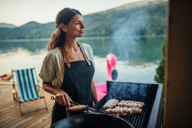 istock Female is barbecuing in the great outdoors 1310097183