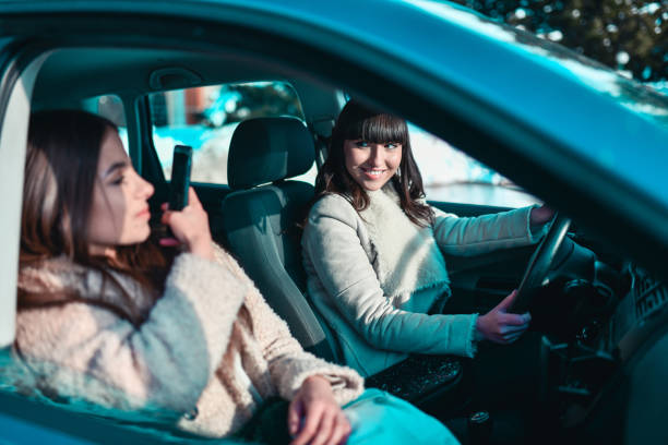 istock Females Photographing Each Other While Driving Car In Snow 1310097492