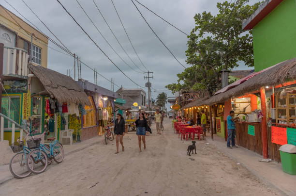 Tourists on a sandy road in Holbox Island, Quintana Roo, Mexico stock photo