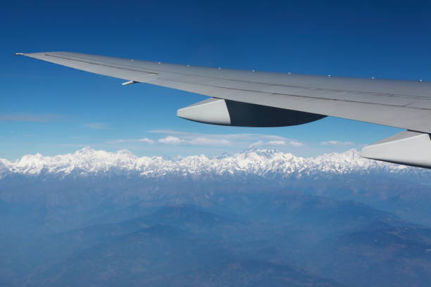 istock Airplane wing with Everest landscape viewed with blue sky and white cloud 1310100365