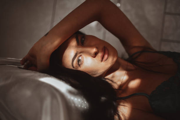 istock Beautiful Female Lying Down On Bed And Relaxing At Home 1310100482