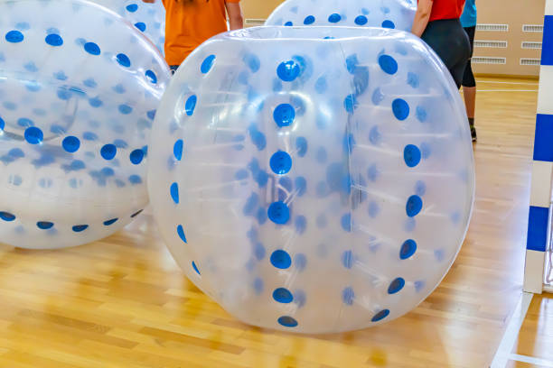 Blue bumper boll bubble balloons in the sports center. Equipment for team building sport game named bumper ball or bubble ball. Zorbsoccer. Blue bumper boll bubble balloons in the sports center. Equipment for team building sport game named bumper ball or bubble ball. Zorbsoccer. High quality photo inflatable soccer balls stock pictures, royalty-free photos & images