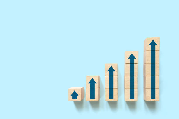 istock Ladder graph career path for business growth success process concept. Wood block stacking step up increase with arrow up and copy space 1310101719