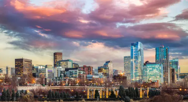 view of the downtown area on a sunset or sunrise in autumn with colorful cloudy sky