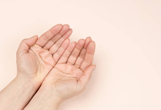 istock two female hands folded palm to palm on a beige background 1310103462