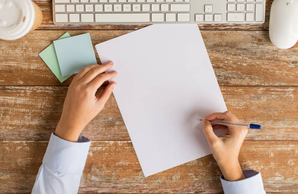 istock close up of hands with paper sheet and keyboard 1310103909
