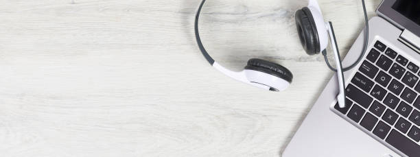 istock Laptop with headphones on white desk 1310104496