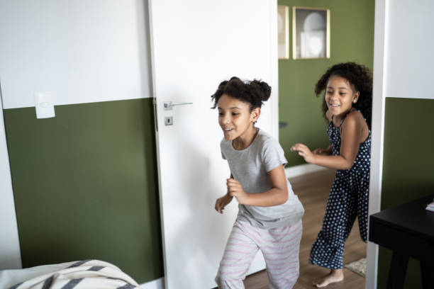 istock Girls running into bedroom at home 1310104510