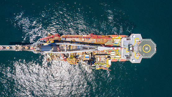 Drone shot of the deck of a drillship in the open ocean