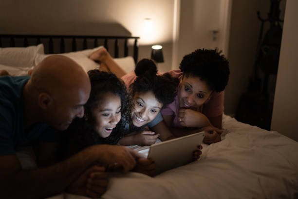 istock Family using digital tablet in bed at home 1310105195