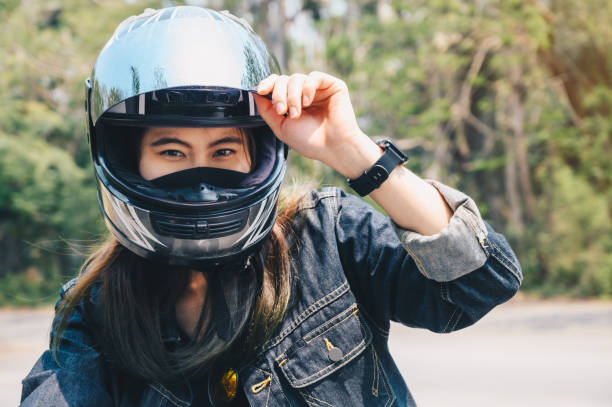 istock Young Asian woman wearing a motorcycle helmet before riding. 1310105995