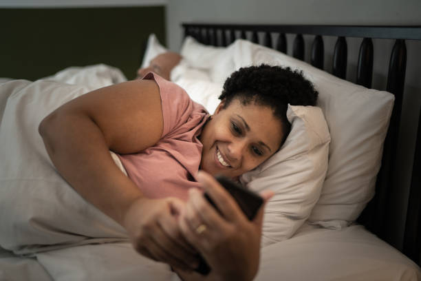 istock Woman in bed using smartphone 1310106051