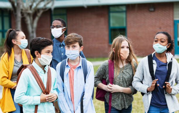istock Middle school students outdoors, wearing face masks 1310106375