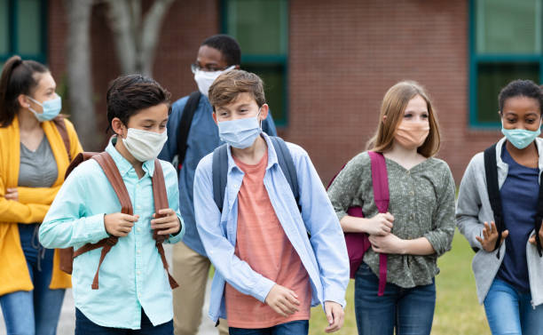istock Middle school students outdoors, wearing face masks 1310106414