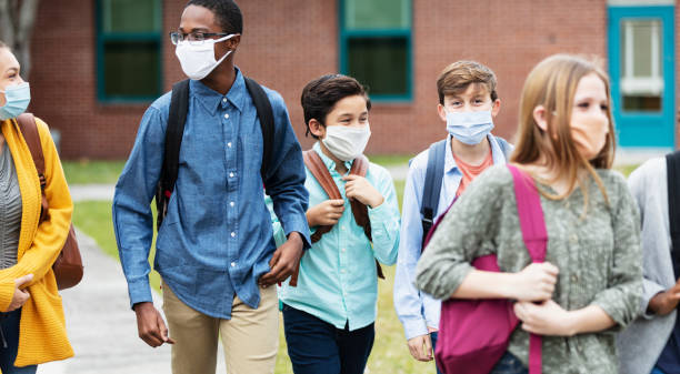 istock Middle school students outdoors, wearing face masks 1310106435