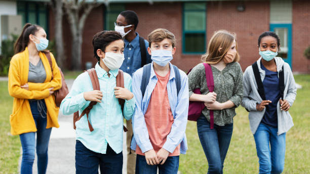 istock Middle school students outdoors, wearing face masks 1310106461