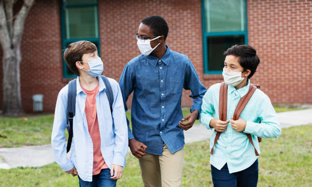 istock Three middle school boys walking, talking outdoors 1310106488