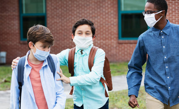 istock Three middle school boys walking, talking outdoors 1310106489