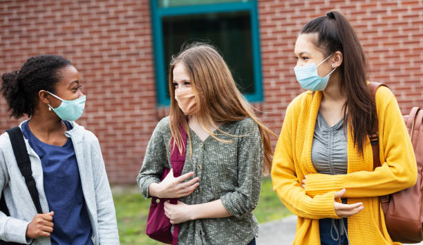 istock Three middle school girls walking, talking outdoors 1310106510