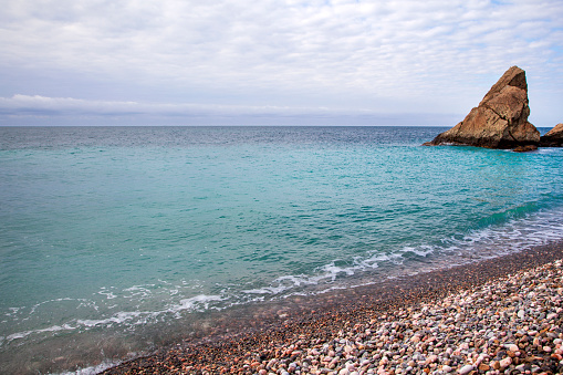 View of the Black Sea coast in Crimea, Cape Fiolent in Sevastopol. Panoramic seascape, calm azure sea, clouds and bright sky.