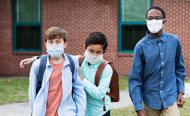 istock Three middle school boys walking, talking outdoors 1310106574