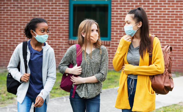 istock Three middle school girls walking, talking outdoors 1310107087