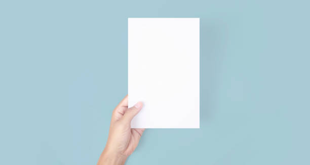 istock Hands holding paper blank for letter paper 1310107180