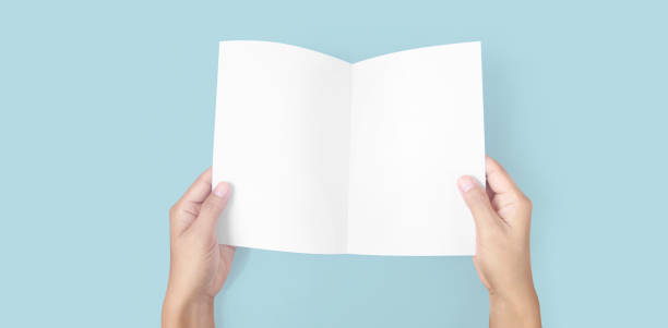 istock Hands holding paper blank for letter paper 1310107181