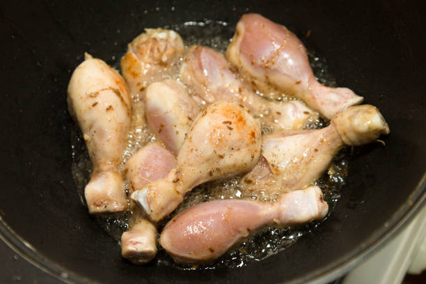 istock Chicken legs are fried in boiling oil. Close-up 1310107419