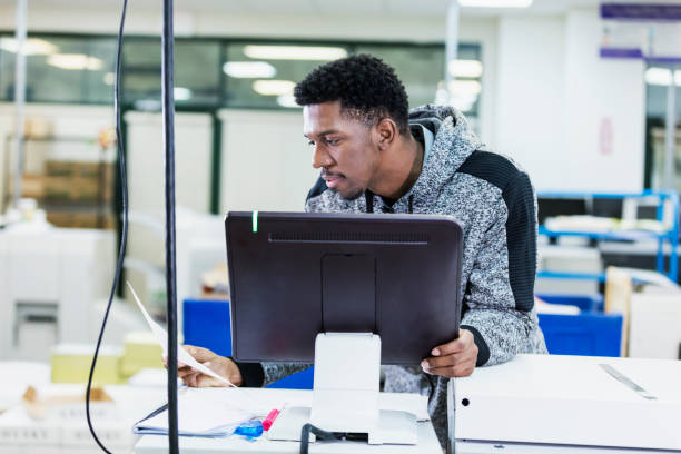 istock African-American man in printing factory using computer 1310107891