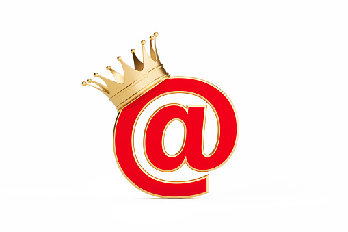 At symbol wearing gold crown isolated on white background. Horizontal composition with clipping path and copy space. E-mail marketing and email campaign concept.