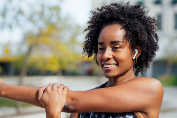 istock Afro athletic woman stretching arms before exercise. 1310108529