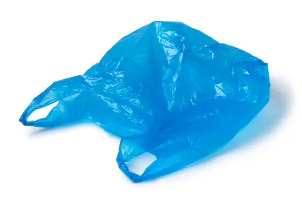 Single empty blue plastic bag isolated on white background