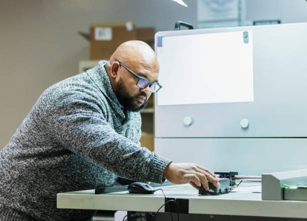 istock Man working in printing factory, quality control 1310108636