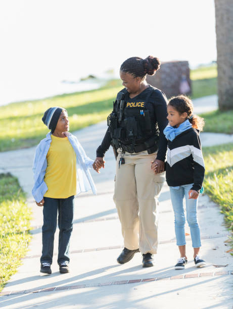 Policewoman in the community, walking with two children