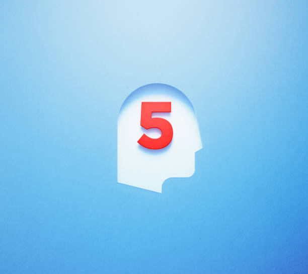 istock Red Number Five Sitting Inside Of A White Cut Out Human Head Shape On Blue Background 1310108741