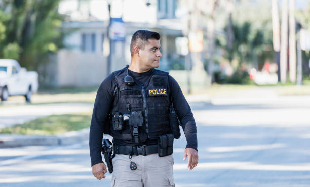 istock Hispanic police officer walking in community 1310108940