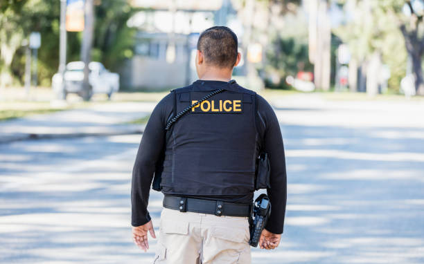 istock Hispanic police officer walking in community 1310108949