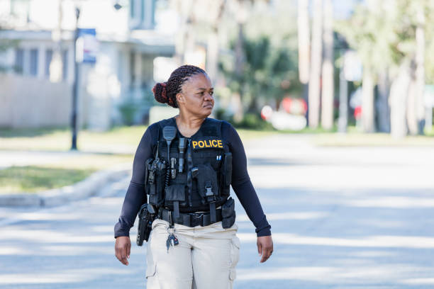 istock African-American policewoman walking in community 1310108973