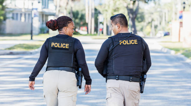 istock Two police officers walking in community 1310108977