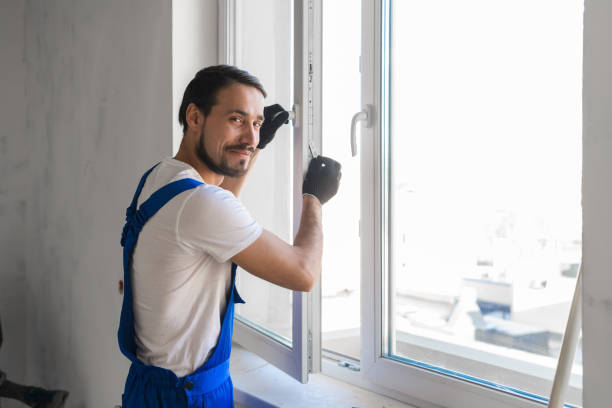 istock Handyman installs the window and looks at the camera 1310109047
