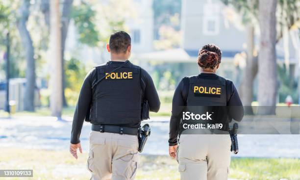 Two Police Officers Walking In Community Stock Photo - Download Image Now - Police Force, USA, Rear View