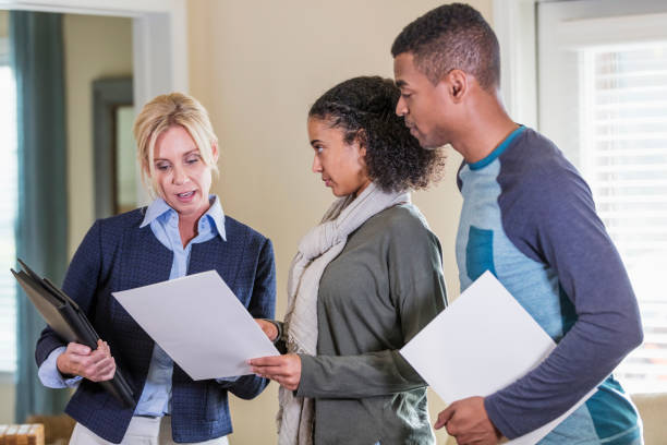 istock Young couple in home with real estate agent 1310109273
