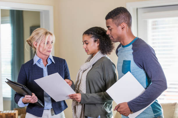 istock Young couple in home with real estate agent 1310109482