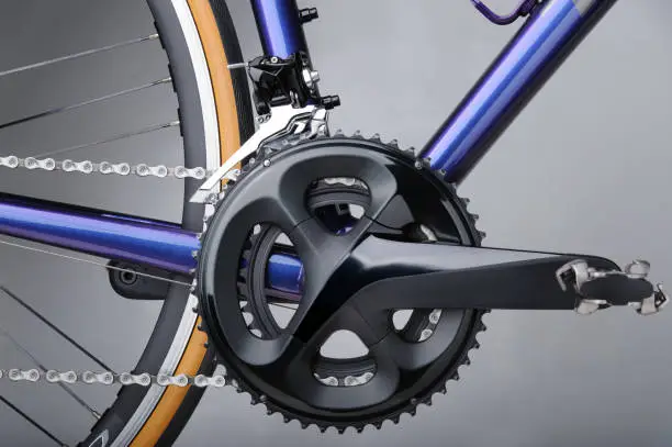 Detail of bicycle components. Closeup of crankset, front derailleur and chains